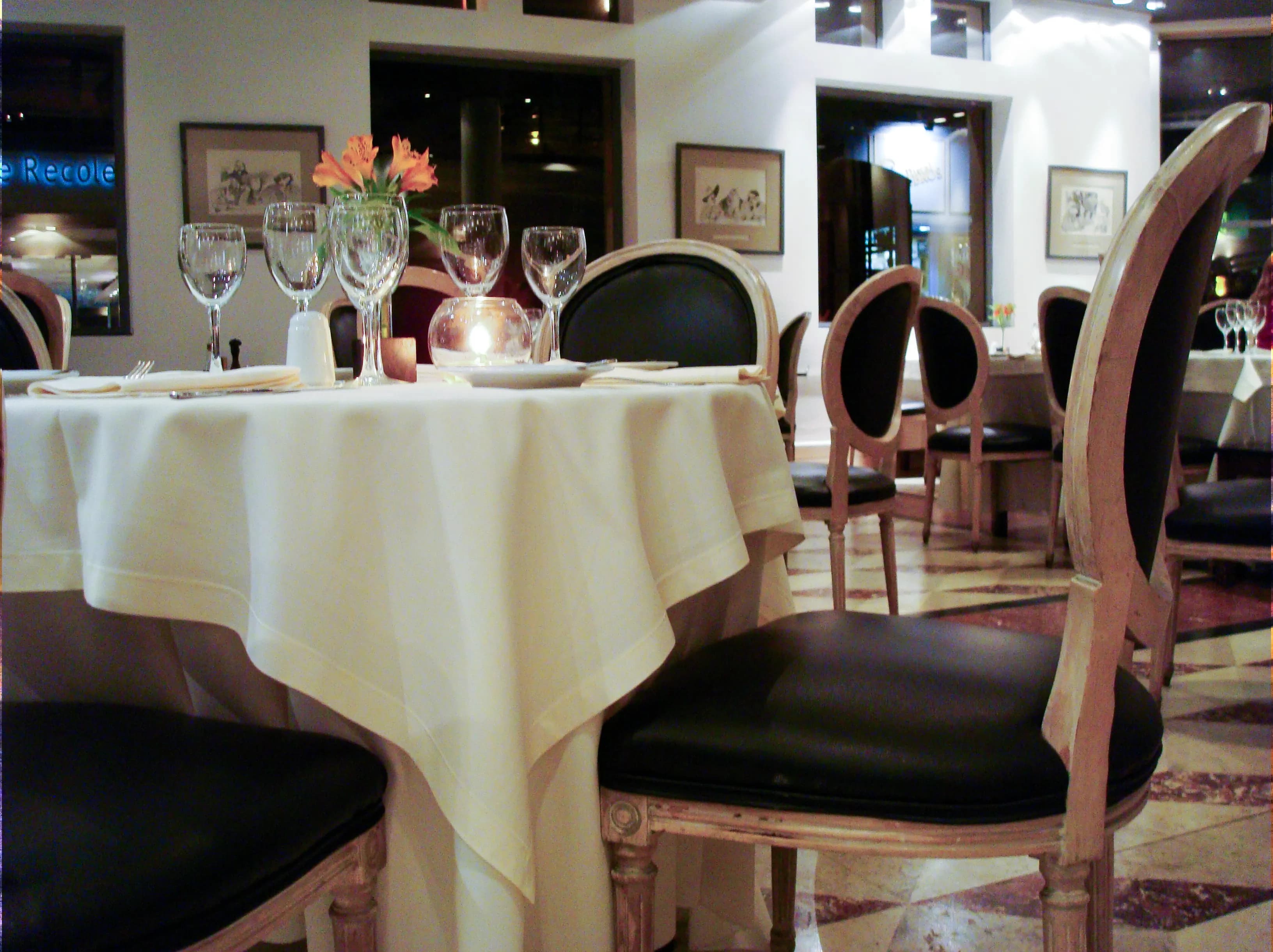 Empty tables, chairs, and place settings inside an Italian restaurant in Recoleta, Buenos Aires, titled Before They Arrived by Francisco Colón.