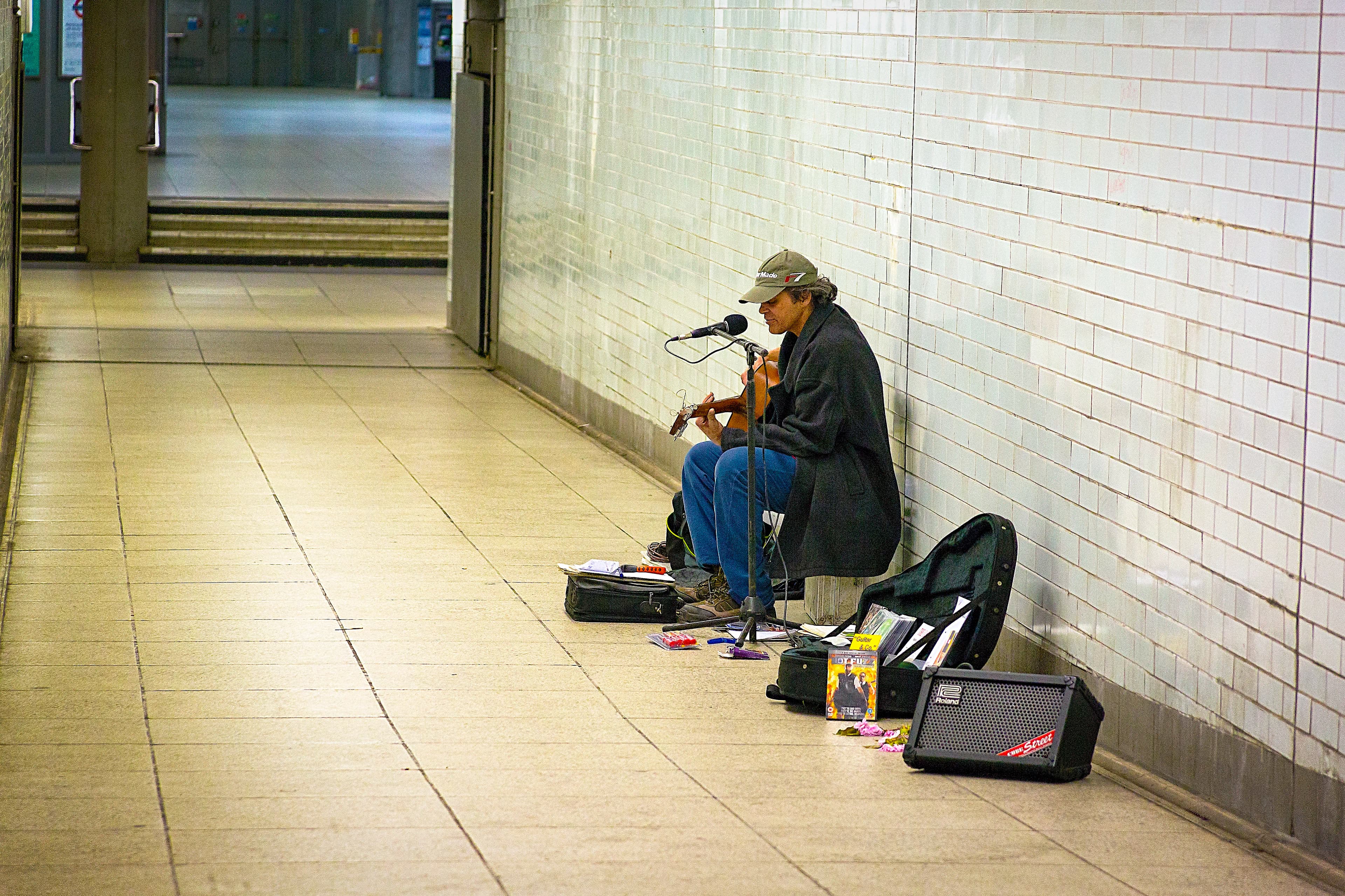 Solitary musician playing inside a pedestrian tunnel near the River Thames in London, titled Songs for Strangers by Francisco Colón.