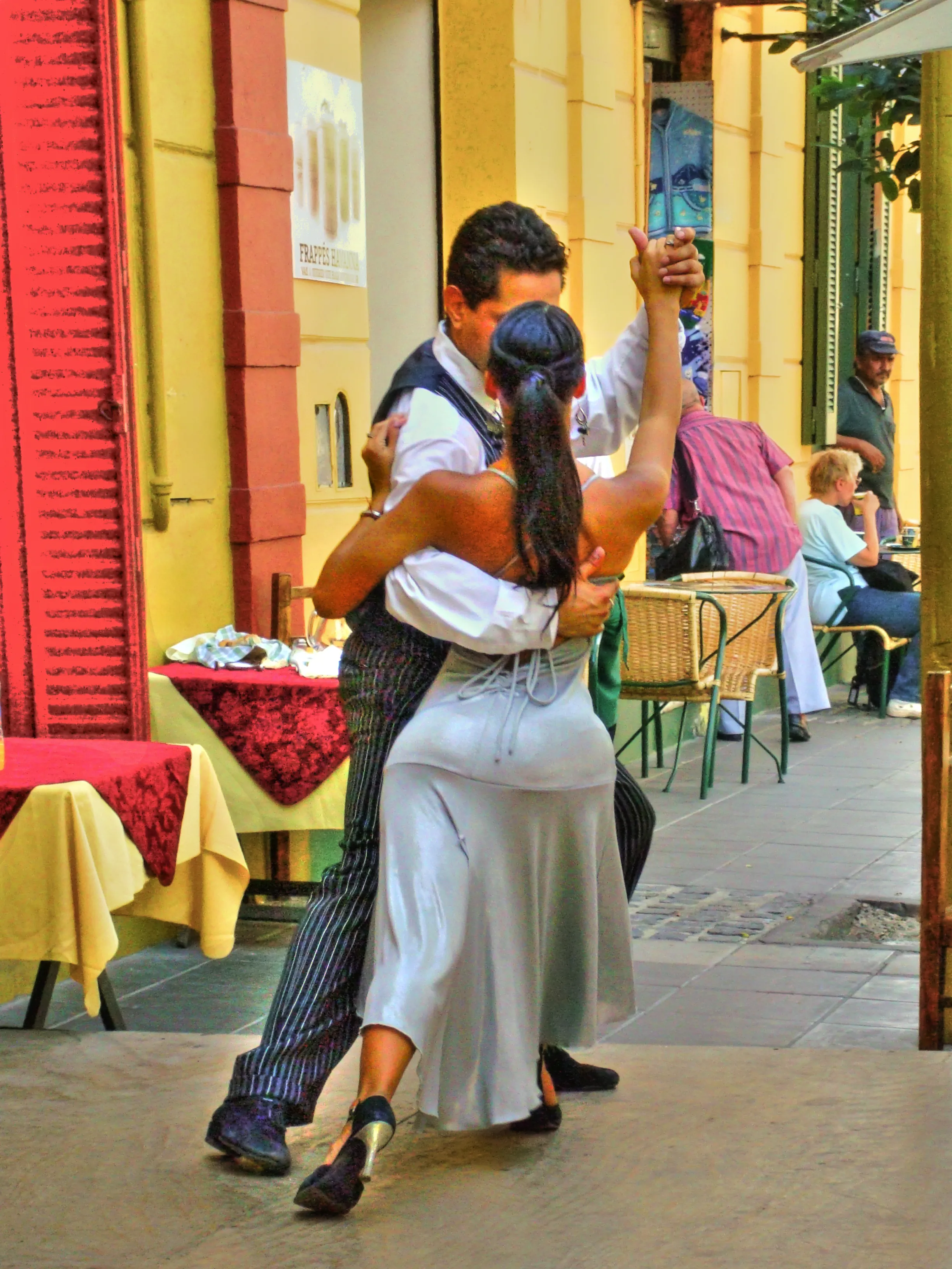 Young tango performer receiving assistance before a public performance in Buenos Aires, titled The Language of Tango by Francisco Colón.