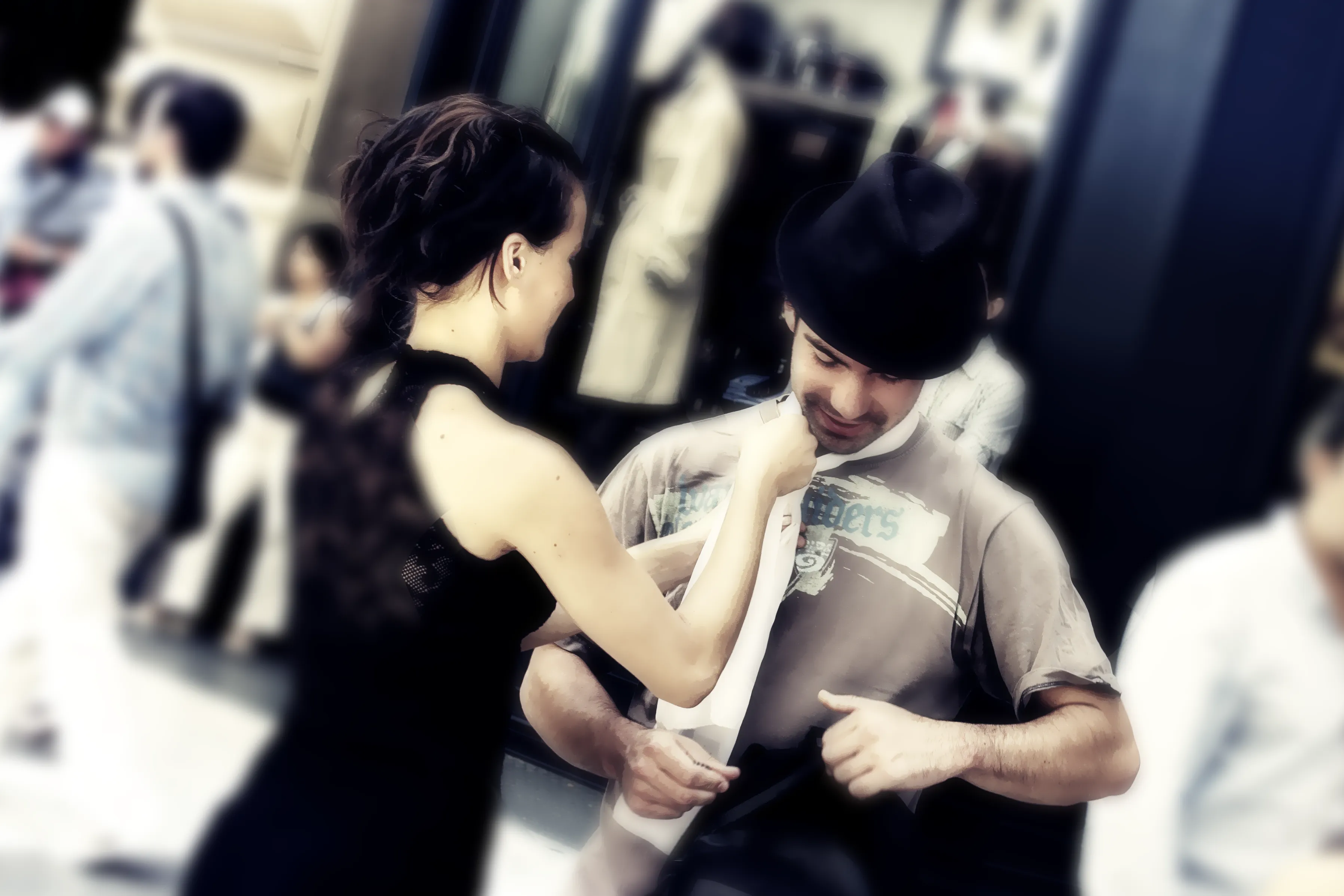 Female tango performer adjusting her partner's scarf before a street performance on Calle Florida in Buenos Aires, titled The Last Touch by Francisco Colón.